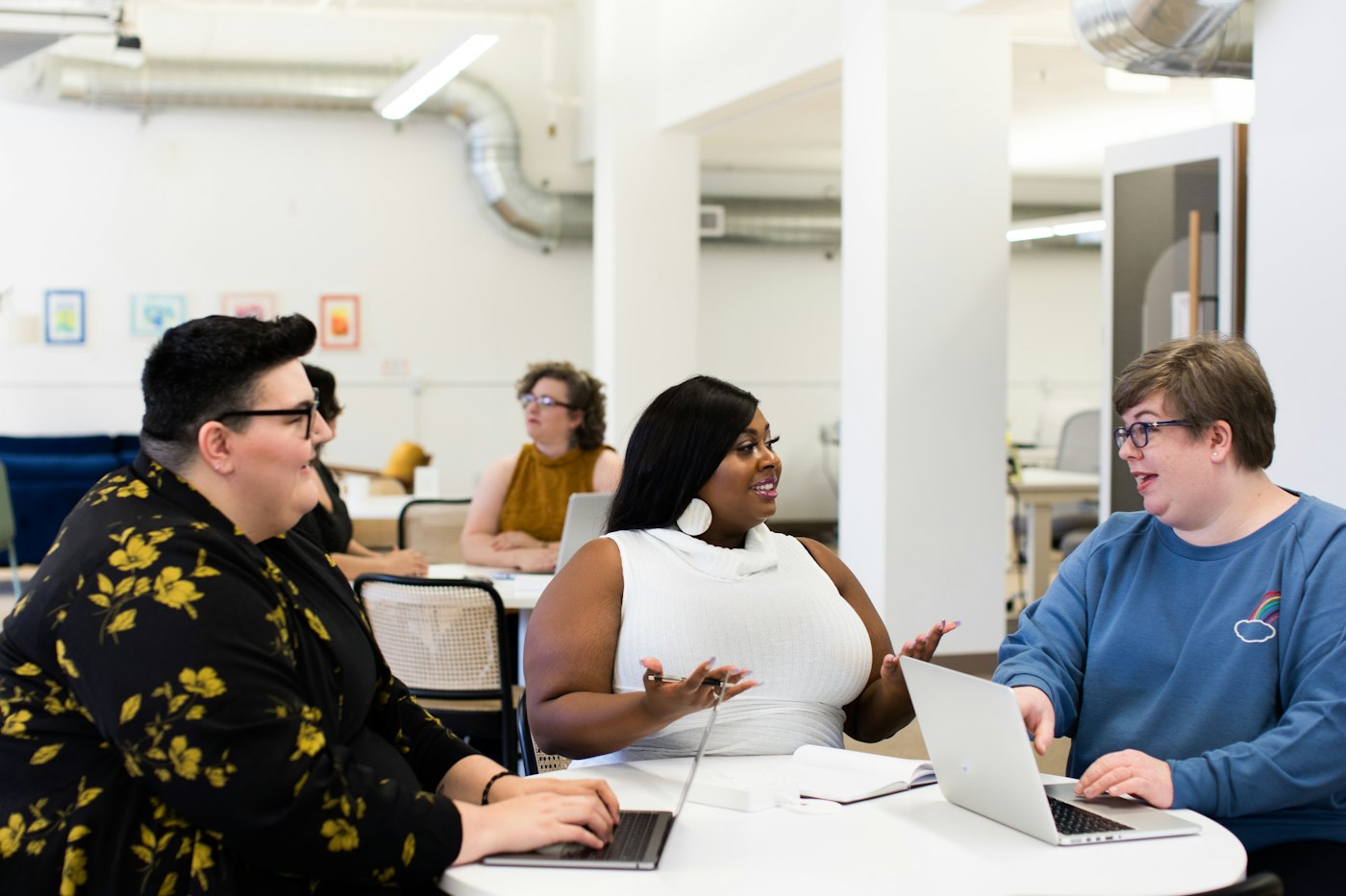 A team working together around a table with laptops
